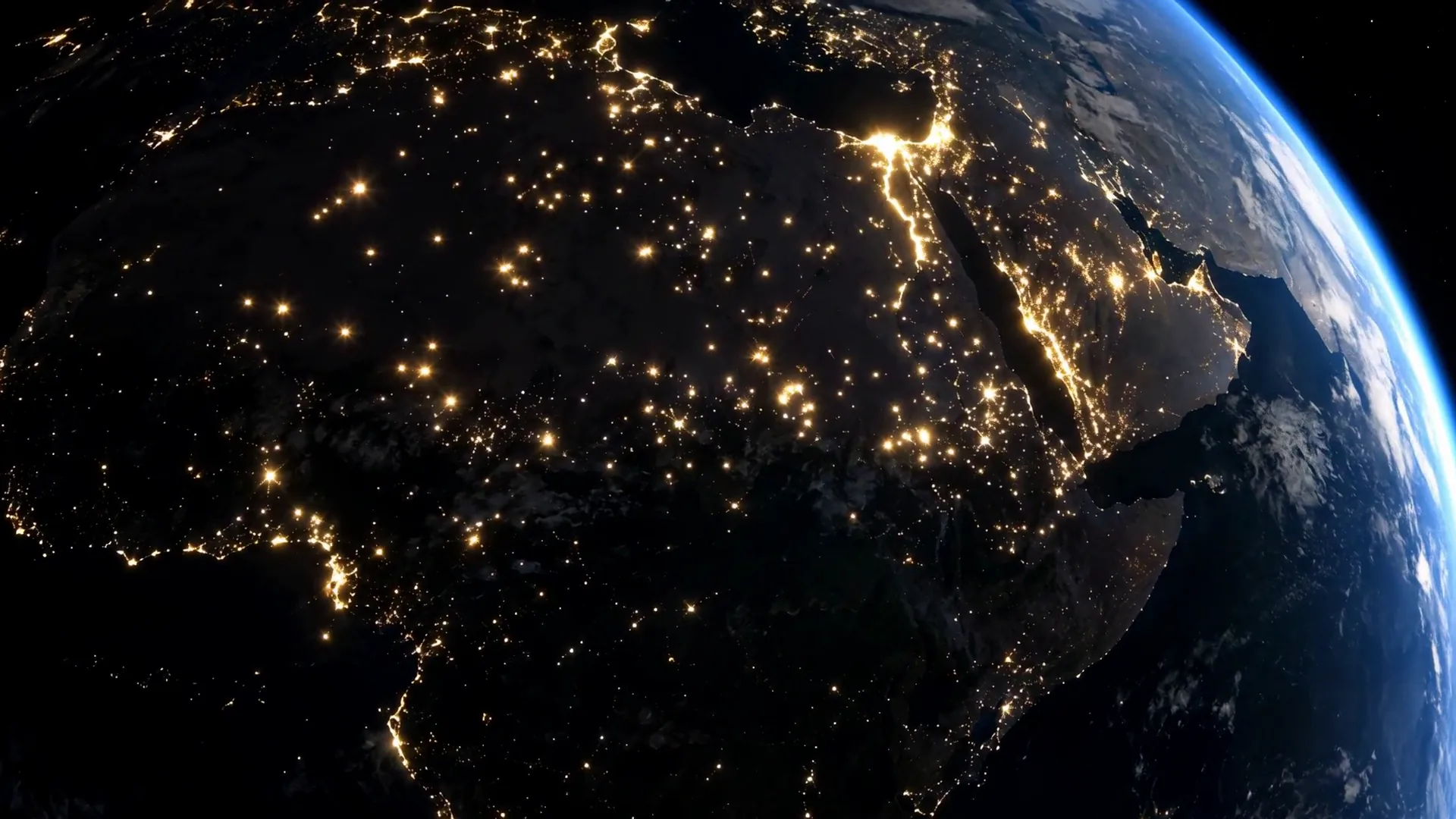 The night side of the Earth, its city lights coming on.